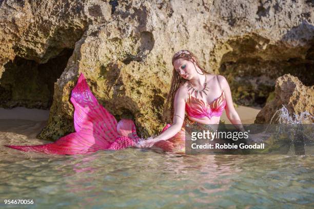 beautiful pink mermaid with long flowing hair.  mettam's pool, north beach - western australian beach. - mermaid tail stock pictures, royalty-free photos & images