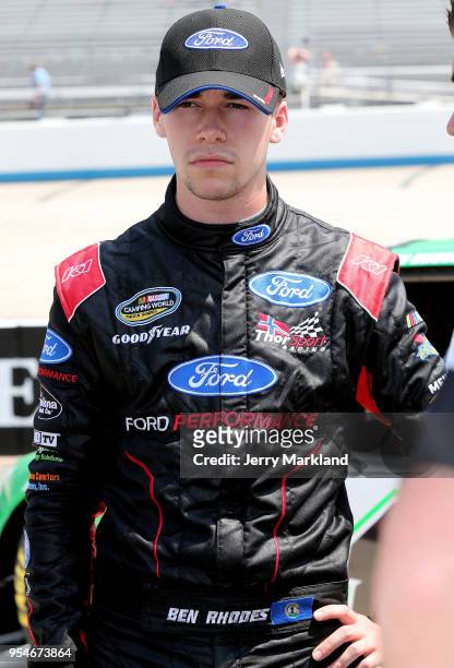 Ben Rhodes, driver of the Alpha Energy Solutions Ford, stands by his car during qualifying for the NASCAR Camping World Truck Series JEGS 200 at...