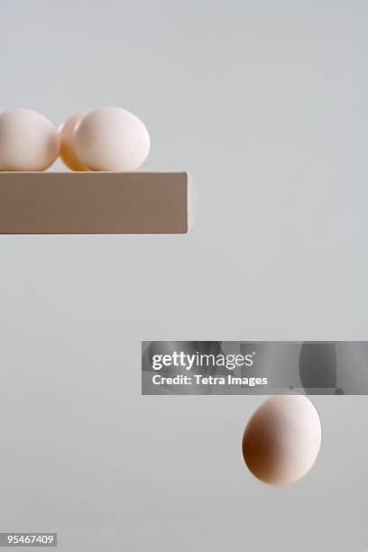 eggs on ledge with one falling - cooking mistake stock pictures, royalty-free photos & images