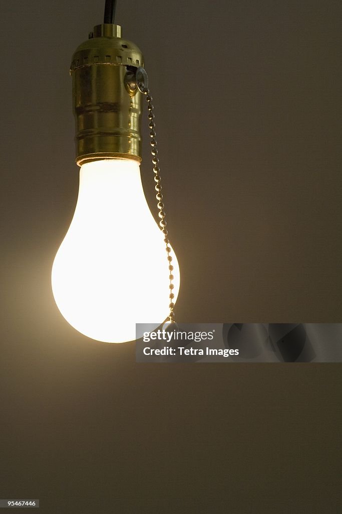 Bare light bulb hanging from ceiling