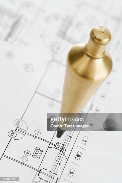 plumb bob over plans - schietlood-meetinstrument stockfoto's en -beelden