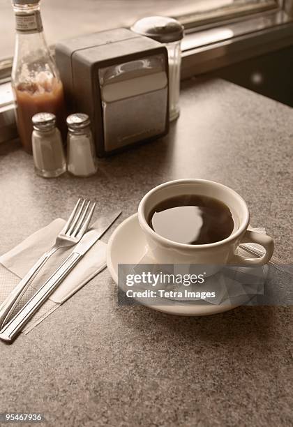 cup of coffee on diner table - napkin holder stock pictures, royalty-free photos & images