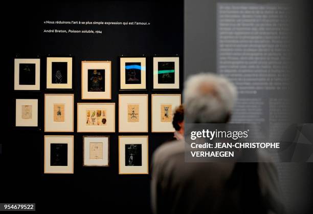 Visitor looks at pieces of art by the couples of artists Andre Breton, Nadja, Valentine Hugo and Jacqueline Lamba during the exhibition "Couples...