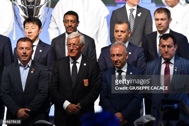 The People's Republic of China national team coach Marcello Lippi poses with UAE coarch Alberto Zaccheroni and other national team coaches during the...