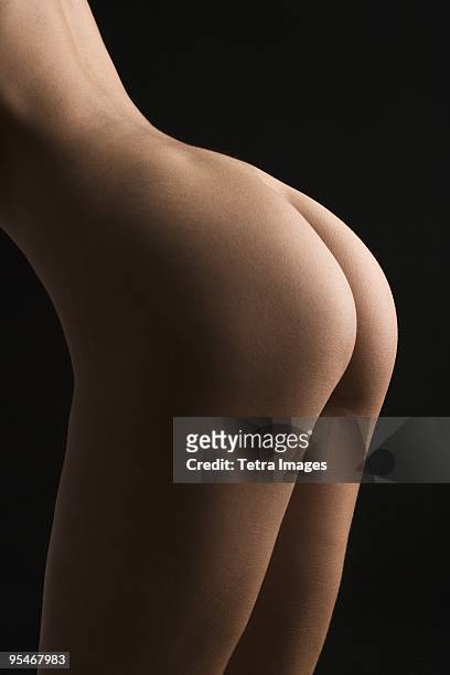 nude woman's bottom - tetra images stock-fotos und bilder