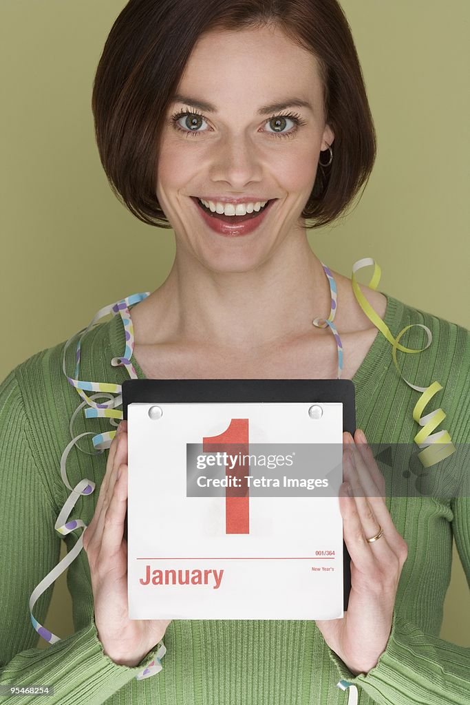 Woman holding a calendar on January first