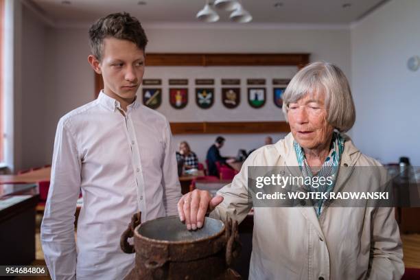 Waldtraut von Finckensein and Patryk Lessman, who discoverd her family belongings one year ago in two buried milk cans, are pictured on May 4, 2018...