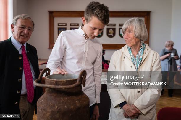 Waldtraut von Finckensein and Patryk Lessman , who discoverd her family belongings one year ago in two buried milk cans, are pictured on May 4, 2018...