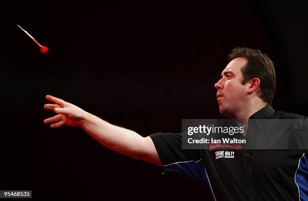 Brendan Dolan of Northern Ireland in action against Raymond van Barneveld of Netherlands during the 2010 Ladbrokes.com World Darts Championship Round...