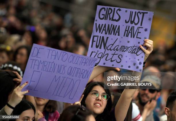 Demonstrators hold placards during a protest in Madrid on May 4 a week after five men, accused of gang raping a woman at Pamplona's bull-running...