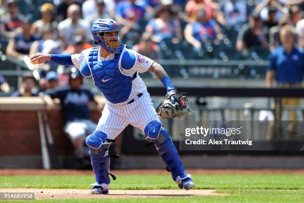 Tomas Nido of the New York Mets makes a throw to first base during the game against the Atlanta Braves at Citi Field on Thursday, May 3, 2018 in the...
