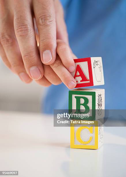 child playing with abc blocks - abc blocks stock pictures, royalty-free photos & images