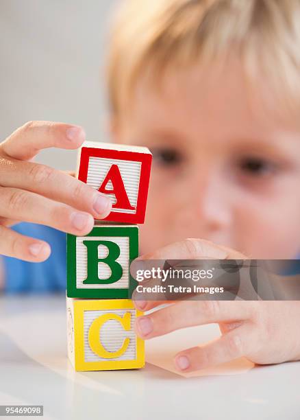 child playing with abc blocks - abc blocks stock pictures, royalty-free photos & images