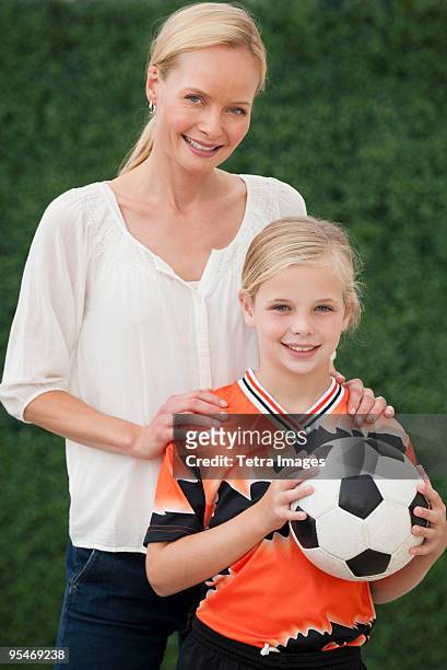 mother and daughter with soccer ball - soccer mom stock pictures, royalty-free photos & images