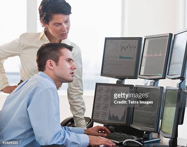 traders studying computer screens - wall street lower manhattan stock pictures, royalty-free photos & images