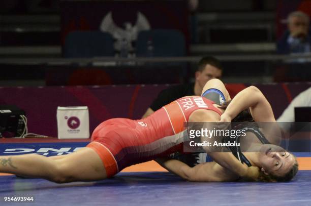 Beste Altug of Turkey competes with Cynthia Vanessa Vescan of France during the women's 72kg category match within the 2018 European Wrestling...