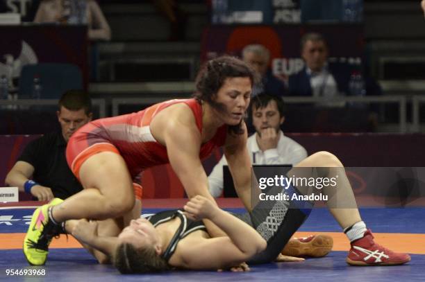 Beste Altug of Turkey competes with Cynthia Vanessa Vescan of France during the women's 72kg category match within the 2018 European Wrestling...