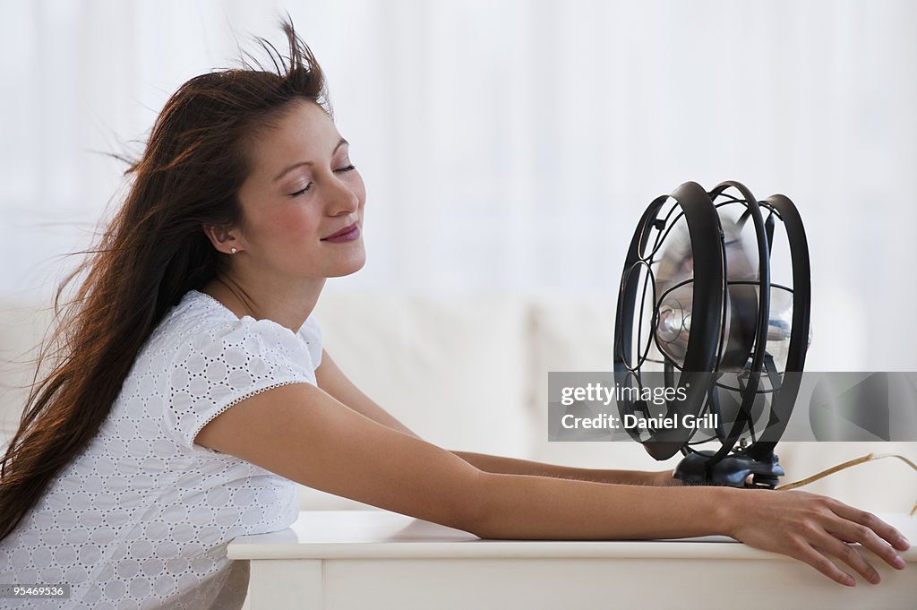 Fan blowing woman's face