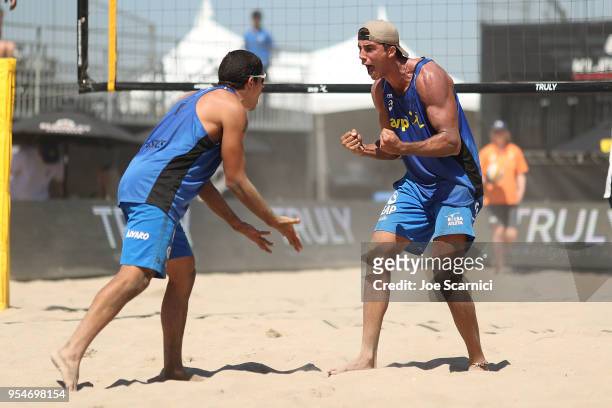 Saymon Barbosa and Alvaro Filho celebrate a point against Phil Dalhausser and Nick Lucena of USA in the second set during the FIVB Huntington Beach...