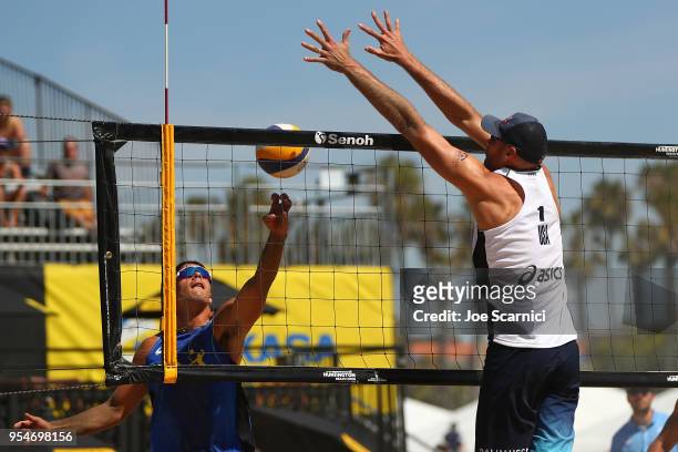 Alvaro Filho of Brazil tries to get the ball past Phil Dalhausser of USA in the second set during the FIVB Huntington Beach Open on May 4, 2018 in...