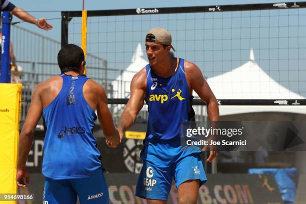 Saymon Barbosa and Alvaro Filho celebrate a point against Phil Dalhausser and Nick Lucena of USA in the second set during the FIVB Huntington Beach...