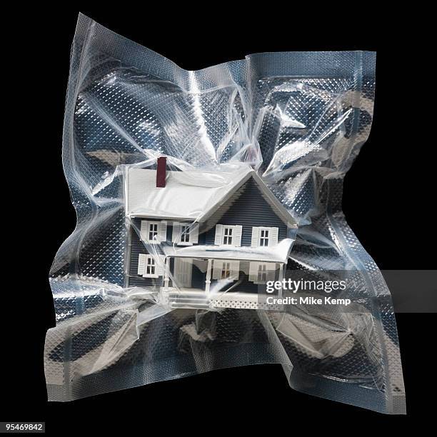 shrink wrapped toy house - mike nilon fotografías e imágenes de stock