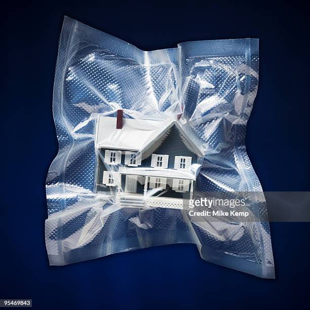 shrink wrapped toy house - mike nilon fotografías e imágenes de stock