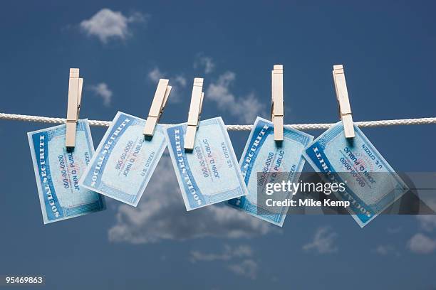 social security cards on clothes line - social security stock pictures, royalty-free photos & images