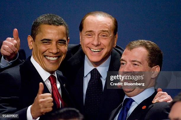 President Barack Obama, left, gestures as he stands with Silvio Berlusconi, Italy's prime minister, center, and Dmitry Medvedev, Russia's president,...