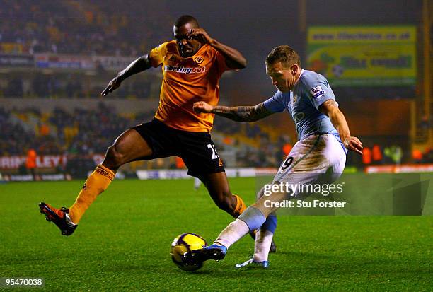 Craig Bellamy of Manchester City gets in a shot at goal despite a challenge by Ronald Zubar of Wolves during the Barclays Premier League match...