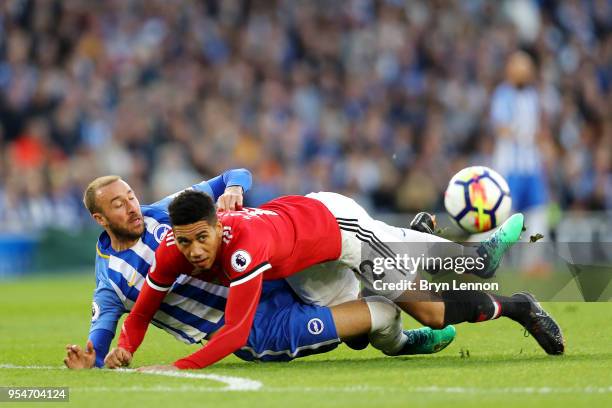 Glenn Murray of Brighton & Hove Albion battles for the ball with Chris Smalling of Manchester United during the Premier League match between Brighton...