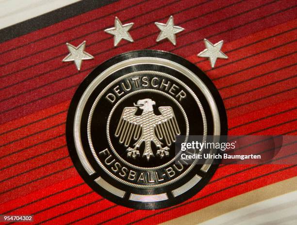 The coat of arms of the German Football Association , and the four stars for the won football world championships, on a jersey of the national...