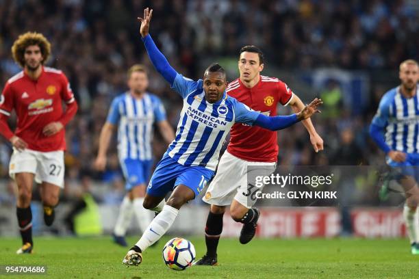 Brighton's Spanish midfielder Jose Izquierdo runs away from Manchester United's Italian defender Matteo Darmian during the English Premier League...