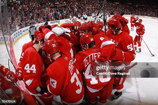 Todd Bertuzzi of the Detroit Red Wings is mobbed by teammates after his overtime game winning goal after a NHL game against the Anaheim Ducks at Joe...