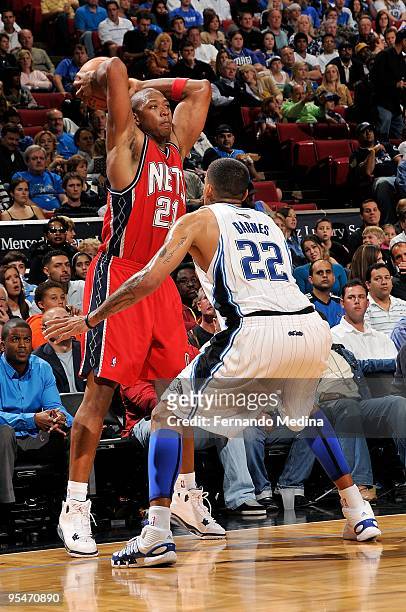 Bobby Simmons of the New Jersey Nets drives the ball against Matt Barnes of the Orlando Magic during the game on November 13, 2009 at Amway Arena in...