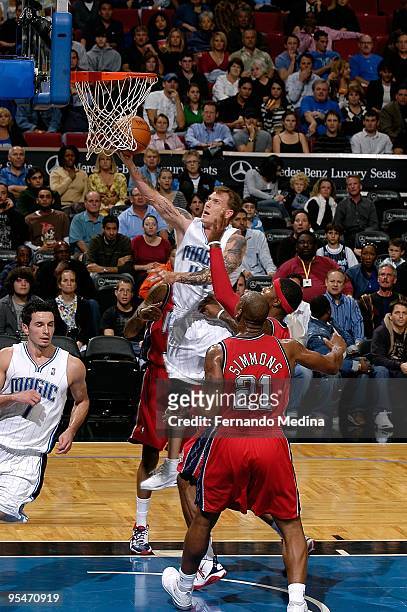 Jason Williams of the Orlando Magic lays up a shot against Bobby Simmons of the New Jersey Nets during the game on November 13, 2009 at Amway Arena...