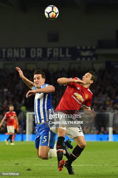 Brighton's English defender Lewis Dunk vies with Manchester United's Italian defender Matteo Darmian during the English Premier League football match...