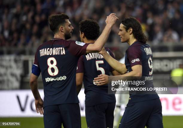 Paris Saint-Germain's Uruguayan forward Edinson Cavani is congratulated by teammates after scoring during the French L1 football match between Amiens...