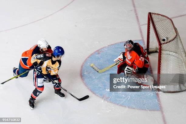 Ryo Miyazaki of Empire Skate battle in the goal mouth with Singapore Hawkers Goalie George Chow during the Mega Ice Hockey 5s match between Singapore...