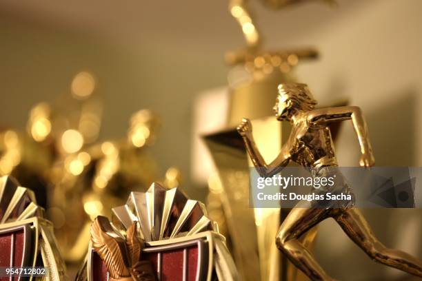 trophy case with a collection of awards - heroes trophy stock pictures, royalty-free photos & images