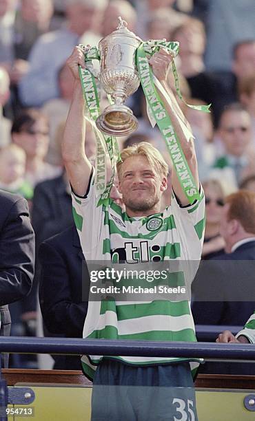 Johann Mjallby of Celtic holds the trophy aloft after the Tennents Scottish cup final win against Hibernian at Hampden Park, Glasgow, Scotland....