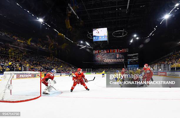 Sweden and Belarus' players fight for the puck during the 2018 IIHF Men's Ice Hockey World Championship match between Sweden and Belarus on May 4,...