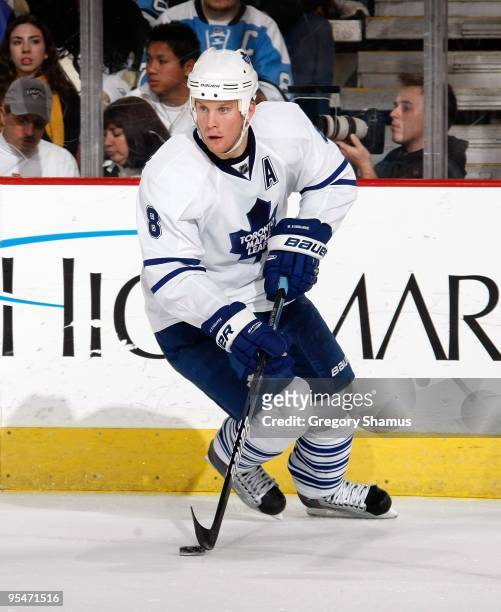 Mike Komisarek of the Toronto Maple Leafs controls the puck against the Pittsburgh Penguins on December 27, 2009 at Mellon Arena in Pittsburgh,...