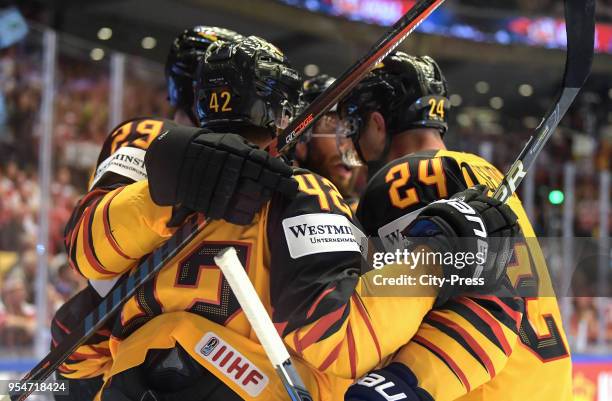 Leon Draisaitl, Yasin Ehliz and Dennis Seidenberg of Germany celebrate after scoring 1:1 during the World Championship game between Germany and...