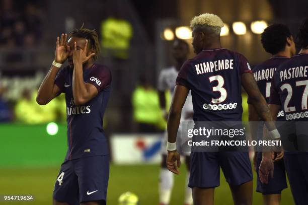 Paris Saint-Germain's French midfielder Christopher Nkunku is congratuled by teammates after scoring during the French L1 football match between...