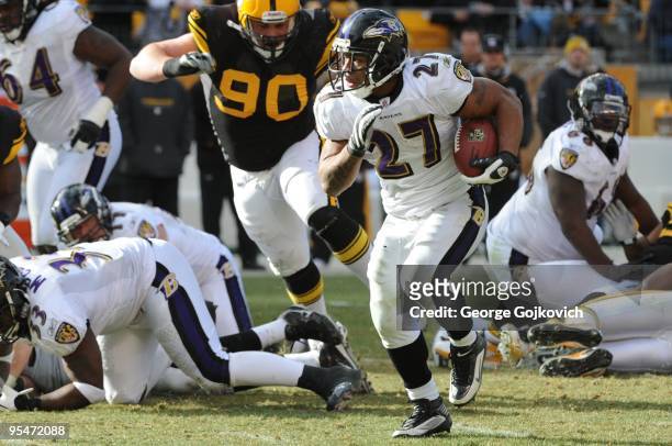 Running back Ray Rice of the Baltimore Ravens is pursued by defensive lineman Travis Kirschke of the Pittsburgh Steelers during a game at Heinz Field...