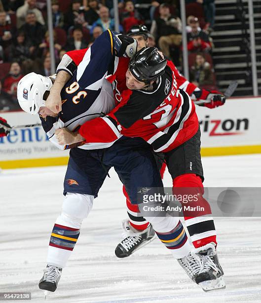 Eric Boulton of the Atlanta Thrashers and Andrew Peters of the New Jersey Devils get into a fight during their game at the Prudential Center on...