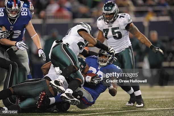 Running back Brandon Jacobs of the New York Giants gets stopped at the line during the game against the Philadelphia Eagles on December 13, 2009 at...