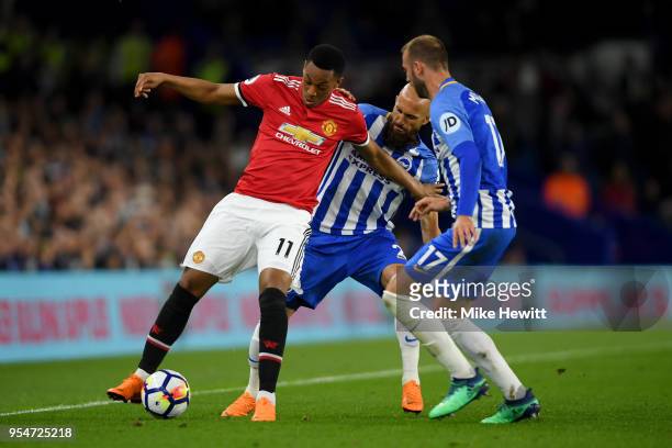 Anthony Martial of Manchester United battles for the ball with Glenn Murray and Bruno Saltor of Brighton & Hove Albion during the Premier League...