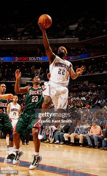 Ronald "Flip" Murray of the Charlotte Bobcats goes for the layup against Jodie Meeks of the Milwaukee Bucks on December 28, 2009 at the Time Warner...